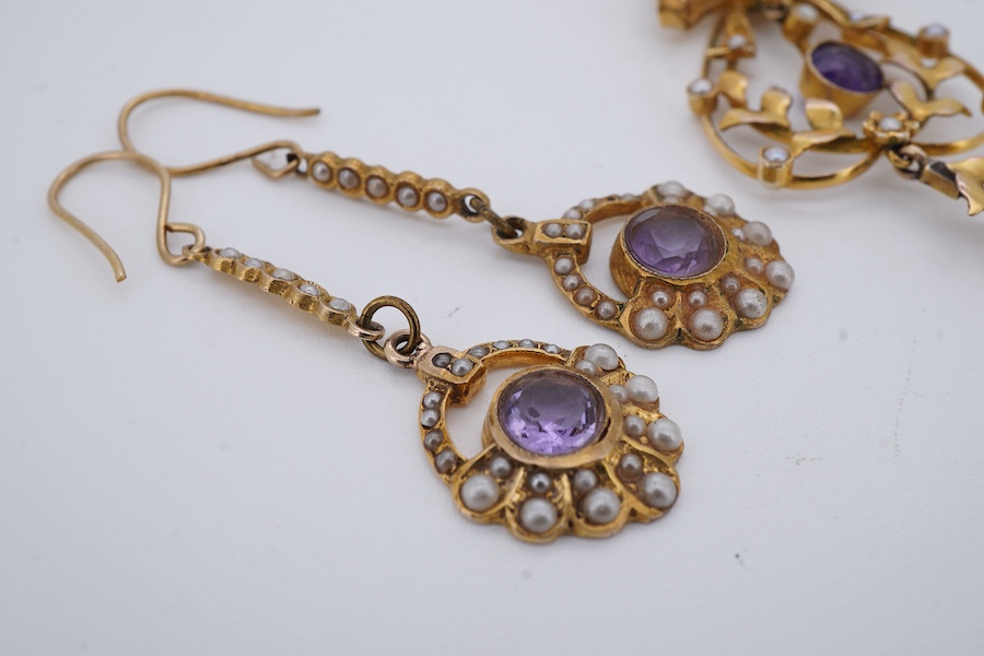 An amethyst and seed pearl demi-parure, early 20th century, comprising: a pendant of foliate design surmounted by a bow, set with oval amethysts and seed pearls, mounted in gold, length 5.2cm, and a matched pair of ameth